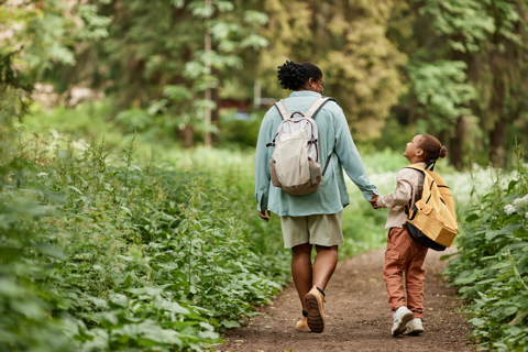 A woman walking with child in forest
