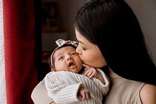 mother kissing baby