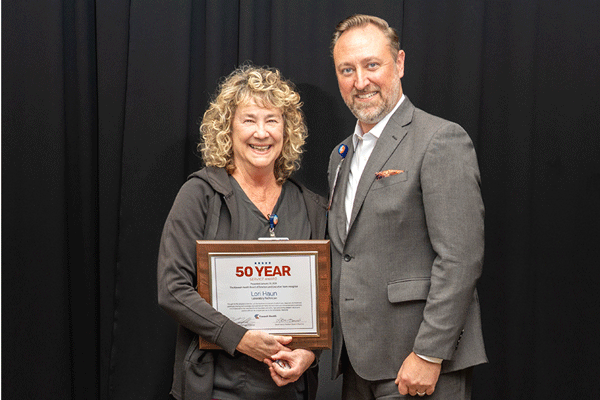 50-year employee Lori Haun poses with Kaweah Health CEO Marc Mertz