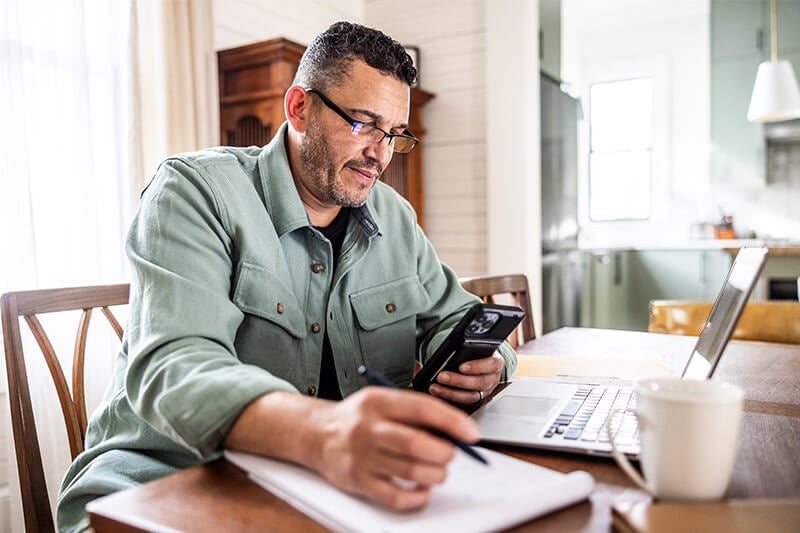 man using smartphone to access lab services online