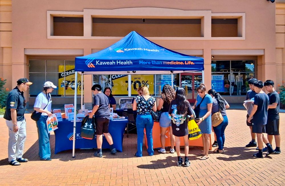 families visiting a kaweah health booth outside tulare outlets