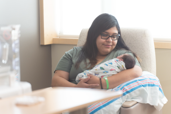 A mother holding a newborn baby