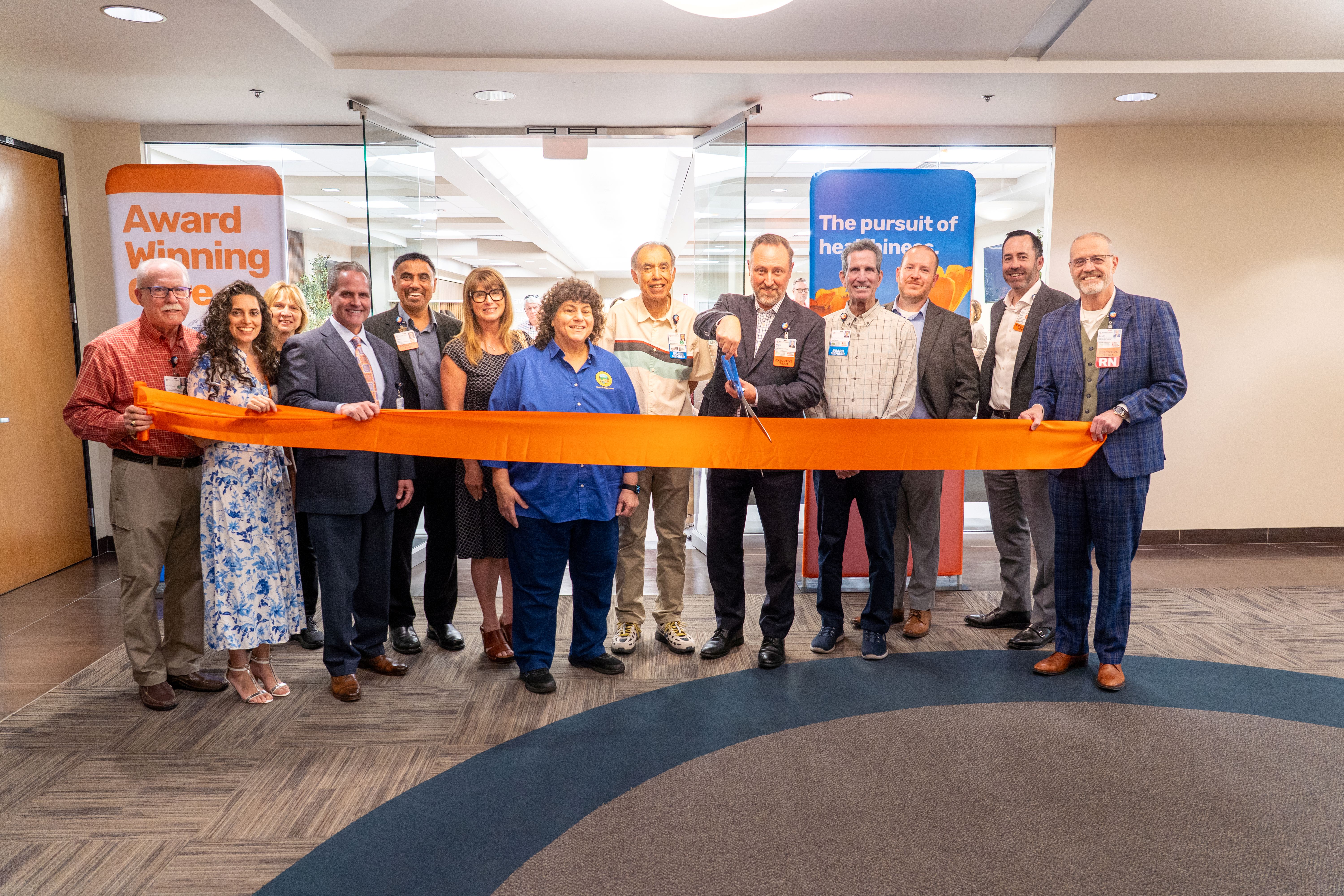A group of Kaweah Health executives and Tulare County dignitaries cut the ribbon opening the new Akers Clinic.