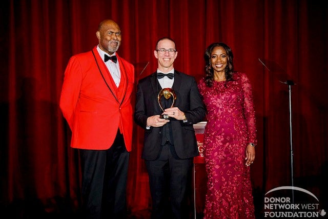 Dr. Ryan Howard, center, receives Donor Network West's President's Award from (left) Bubba Paris, Executive Director of the Donor Network West Foundation, and Dr. Janice Whaley, Donor Network West CEO.